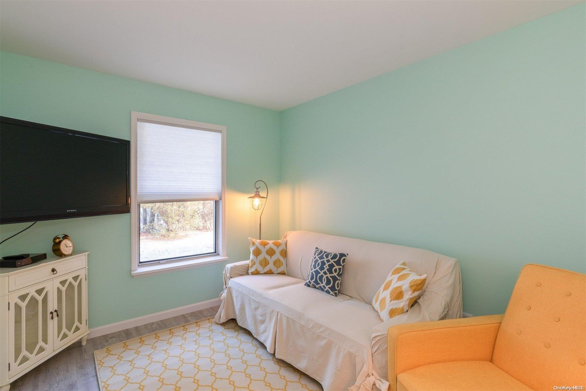 37 Halsey Road Remsenburg, NY 11960 - Photo 16 of 17 a living room with furniture and a flat screen tv