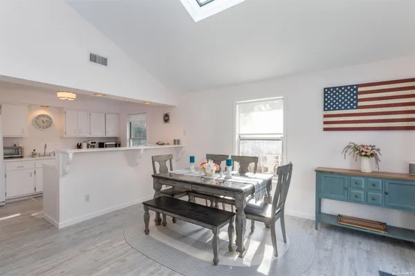 a dining room with furniture and window