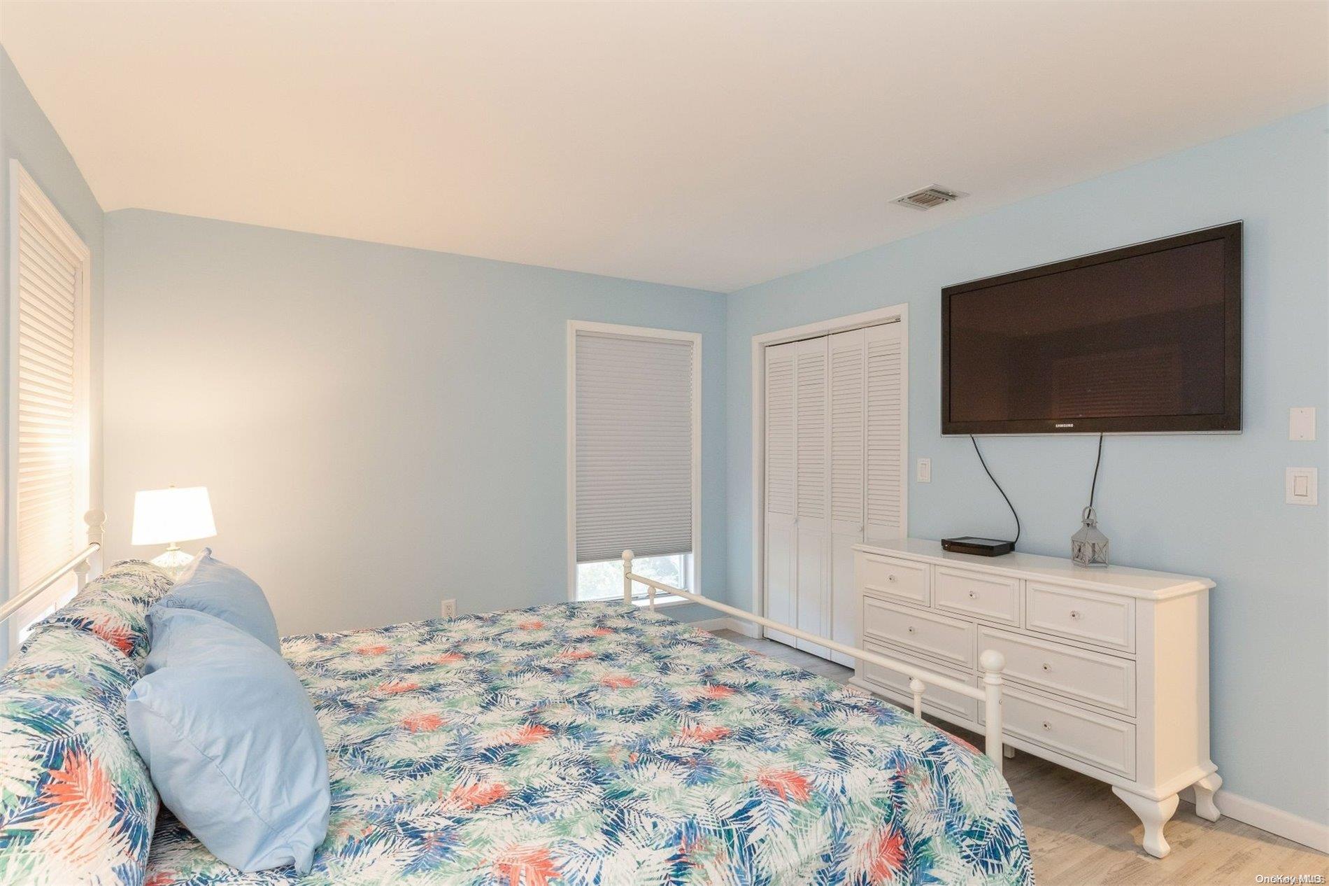 37 Halsey Road Remsenburg, NY 11960 - Photo 10 of 17 a bedroom with a bed and a flat screen tv