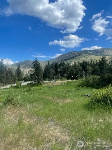a view of a green field with sunset