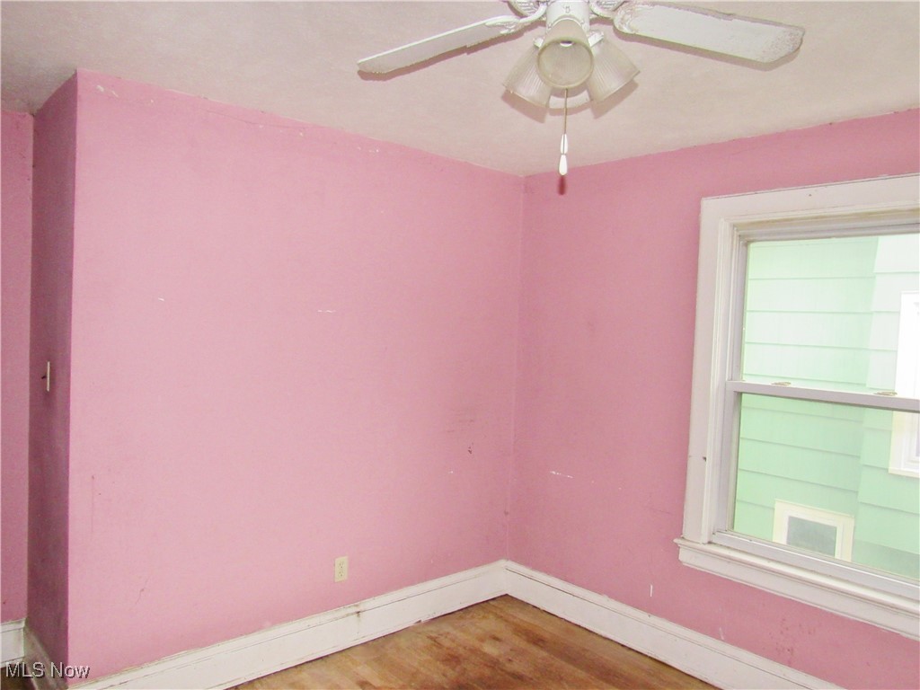 14450 Superior Road Cleveland, OH 44118 - Photo 21 of 35 Empty room with wood finished floors, a ceiling fan, and baseboards