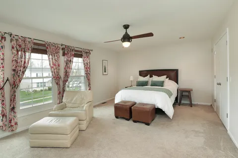 a bedroom with a bed couch and window