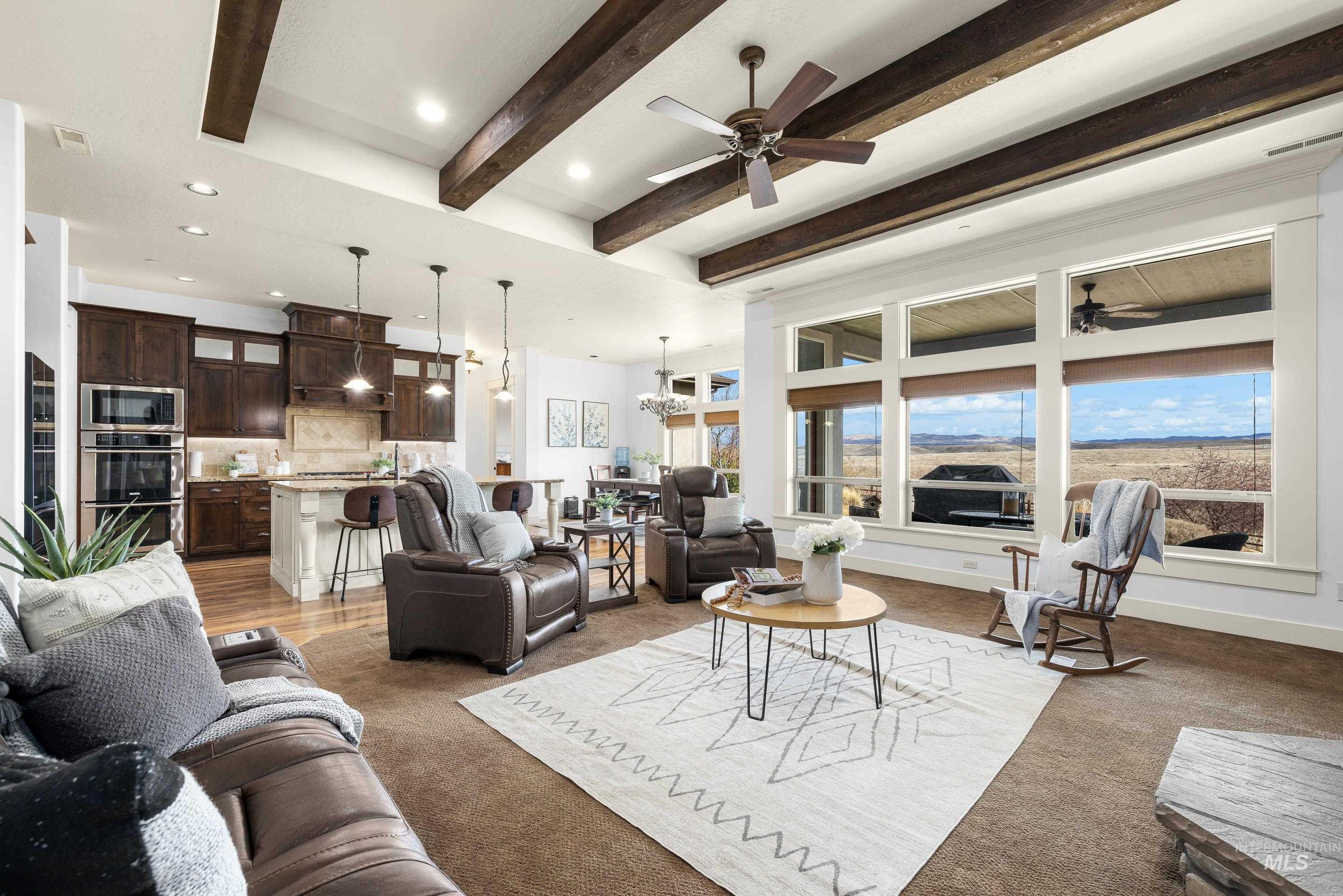 7521 North Grand Ridge Lane Eagle, ID 83616 - Photo 12 of 50 Living room featuring beamed ceiling, recessed lighting, a ceiling fan, and light colored carpet