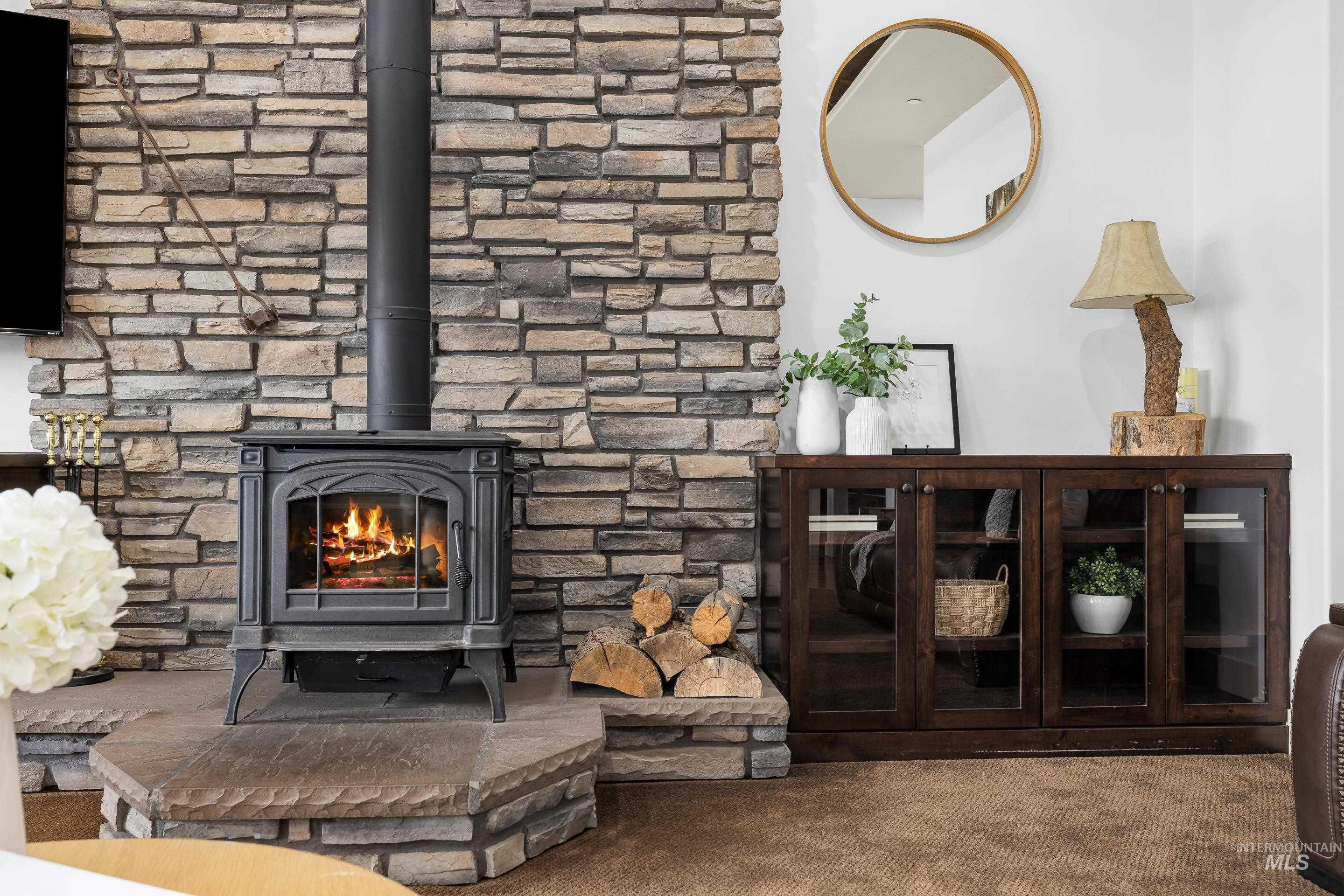 7521 North Grand Ridge Lane Eagle, ID 83616 - Photo 13 of 50 Detailed view of carpet floors and a wood stove