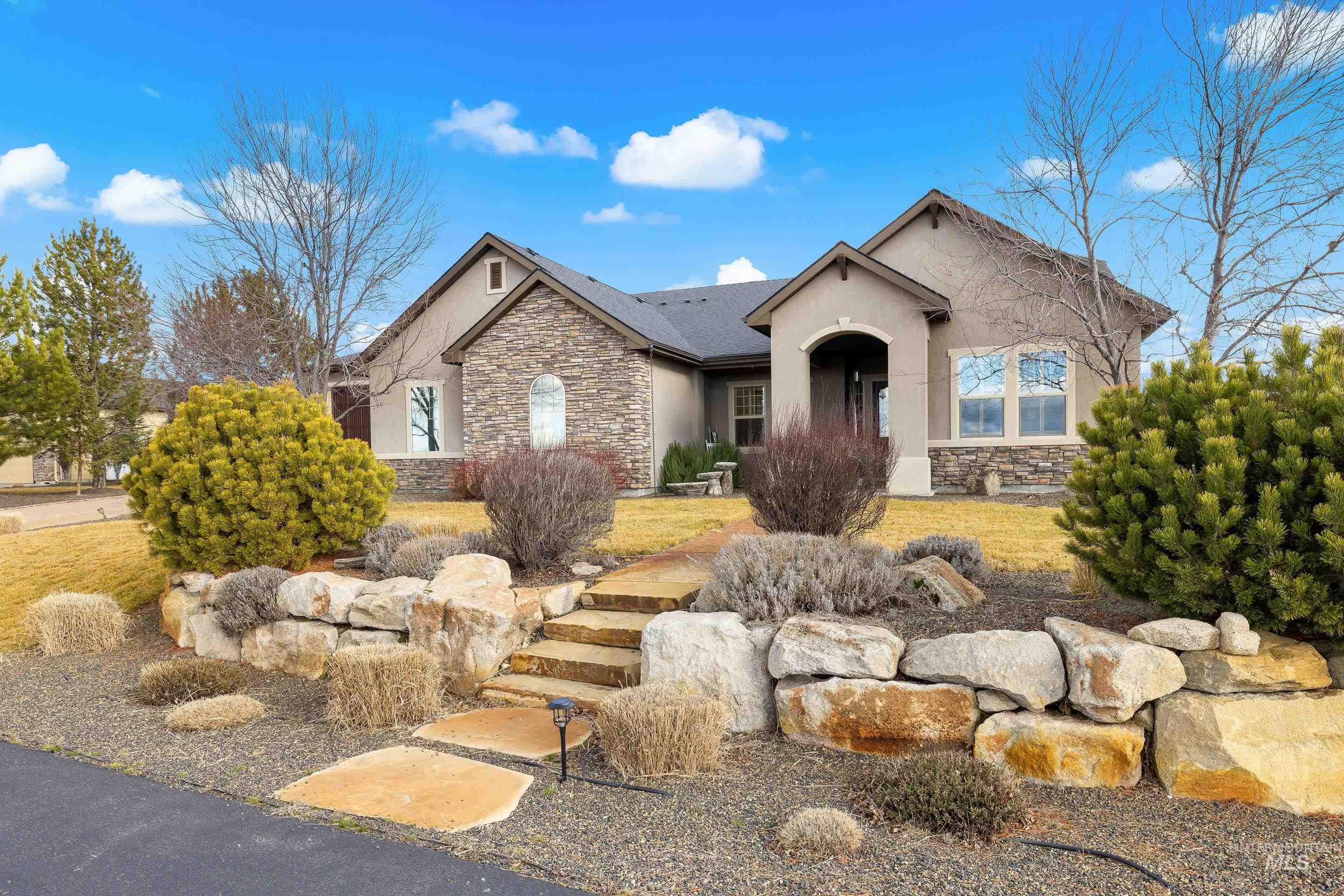 7521 North Grand Ridge Lane Eagle, ID 83616 - Photo 2 of 50 Ranch-style house with stone siding and stucco siding