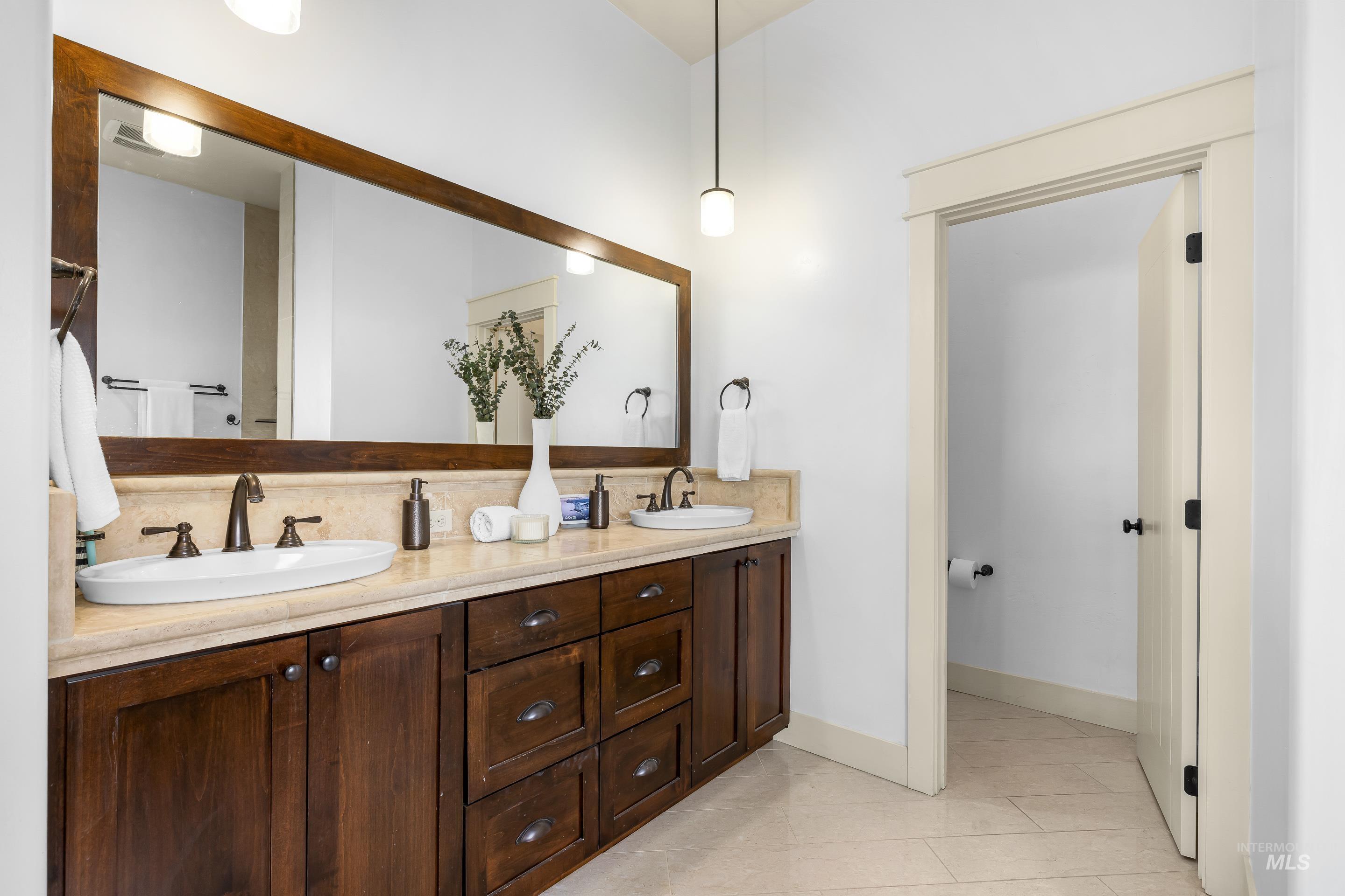 7521 North Grand Ridge Lane Eagle, ID 83616 - Photo 32 of 50 Bathroom with double vanity and light tile patterned floors