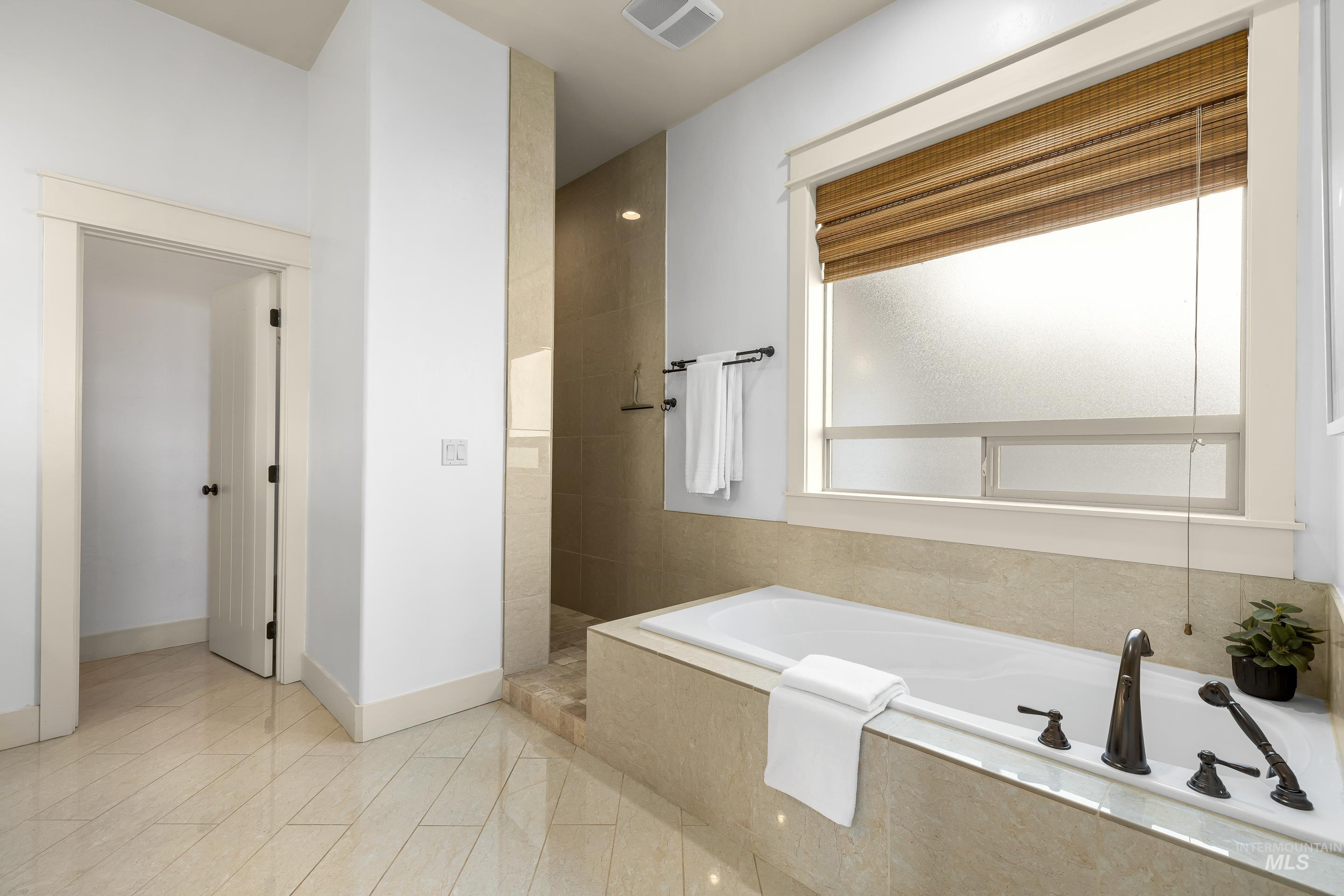 7521 North Grand Ridge Lane Eagle, ID 83616 - Photo 33 of 50 Full bathroom with a bath and a walk in shower