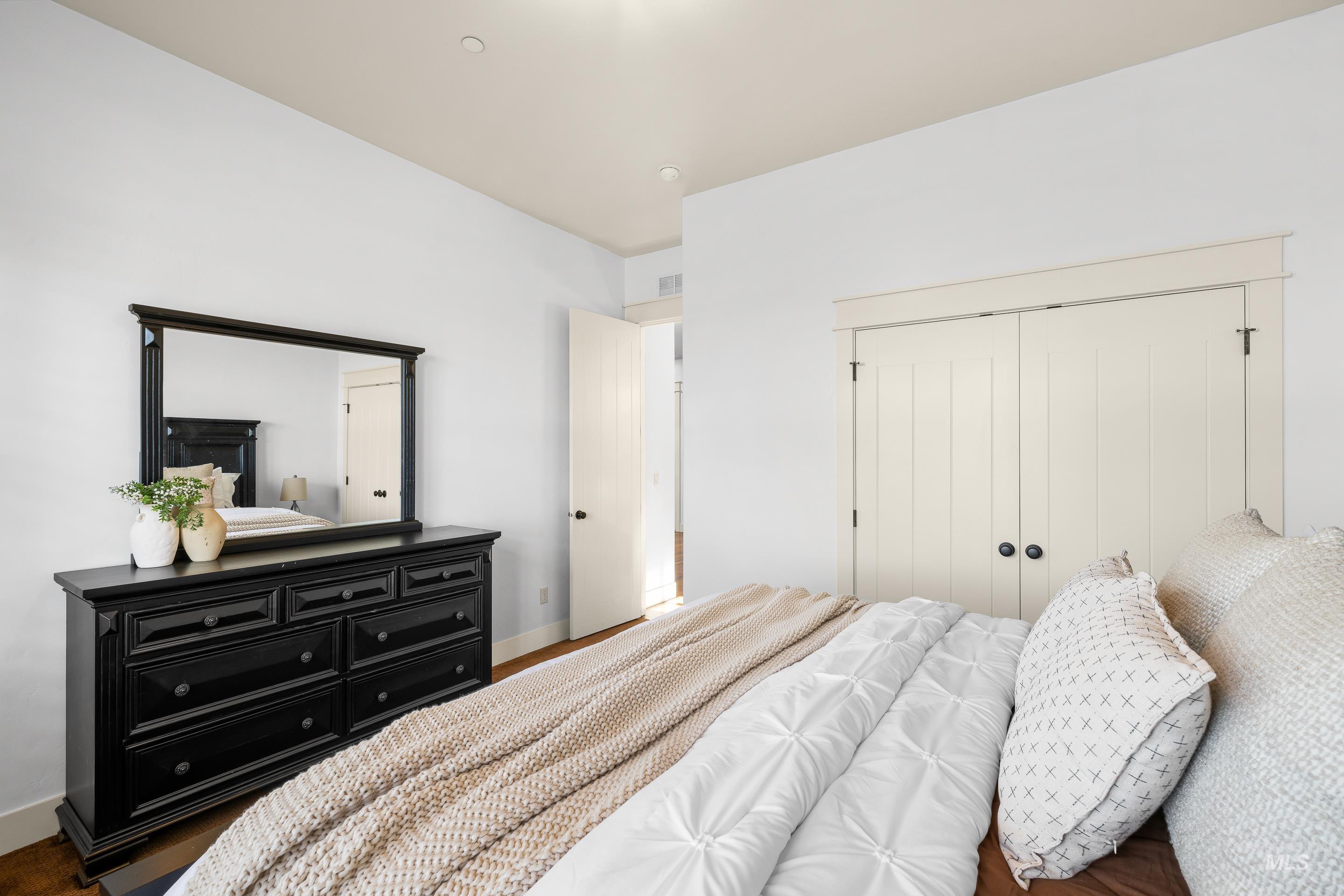 7521 North Grand Ridge Lane Eagle, ID 83616 - Photo 35 of 50 Bedroom featuring a closet and dark wood-type flooring