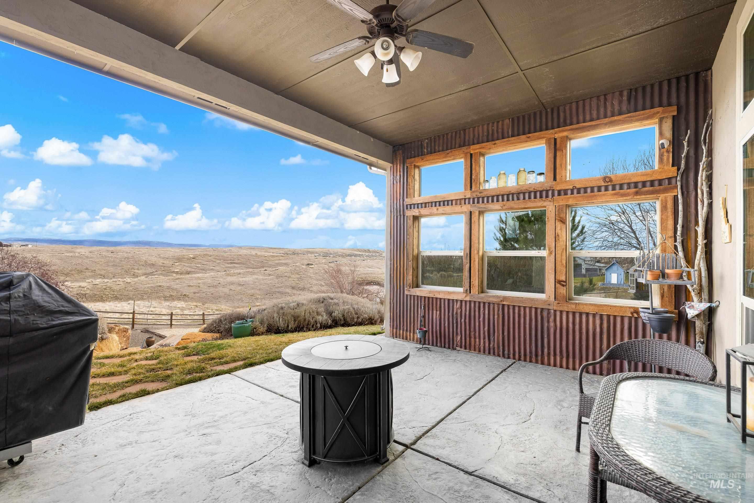 7521 North Grand Ridge Lane Eagle, ID 83616 - Photo 39 of 50 View of patio with a ceiling fan and a rural view