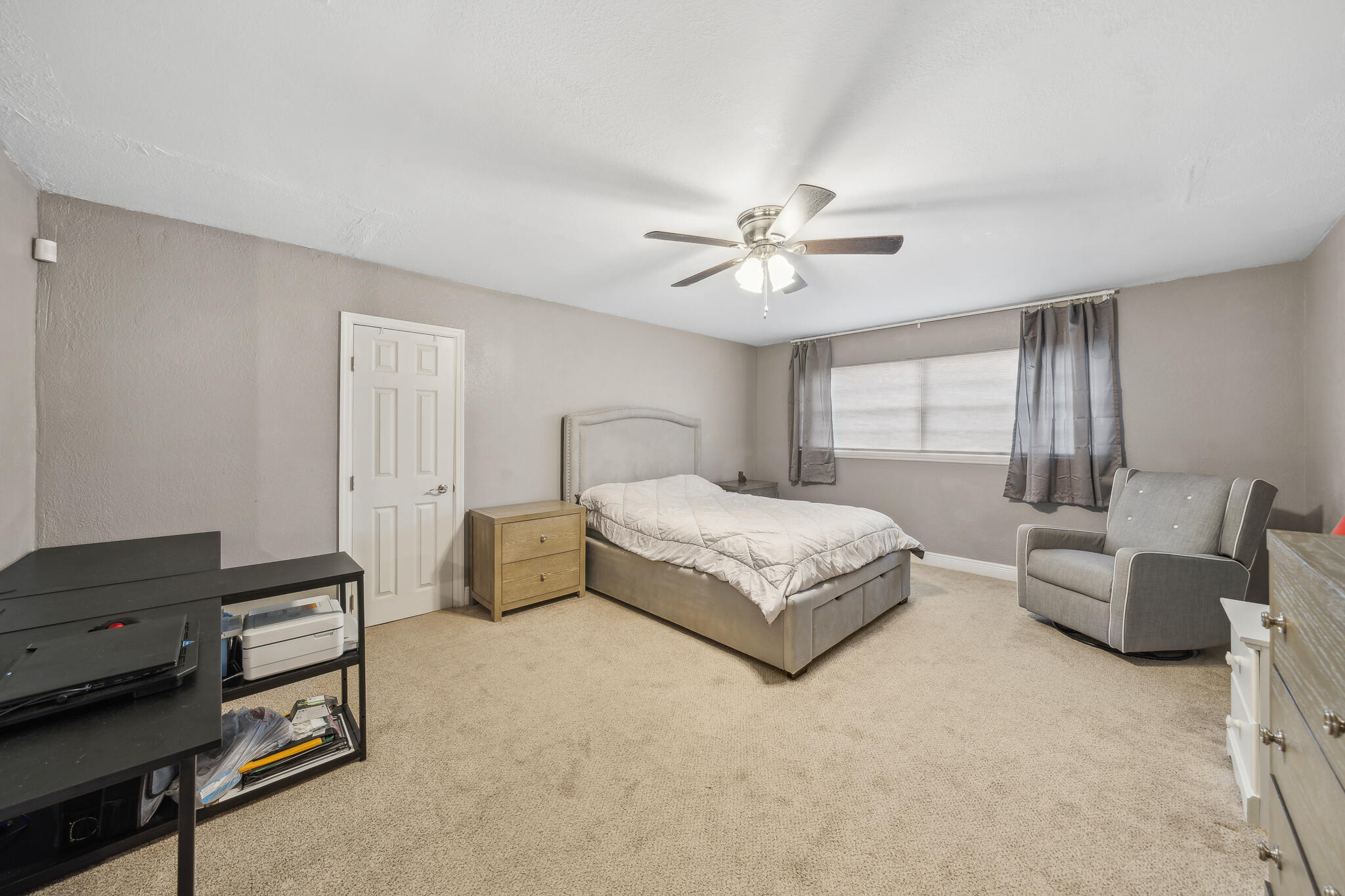 2936 Shepard Drive Rockledge, FL 32955 - Photo 11 of 25 a spacious bedroom with a bed a couch and a chandelier