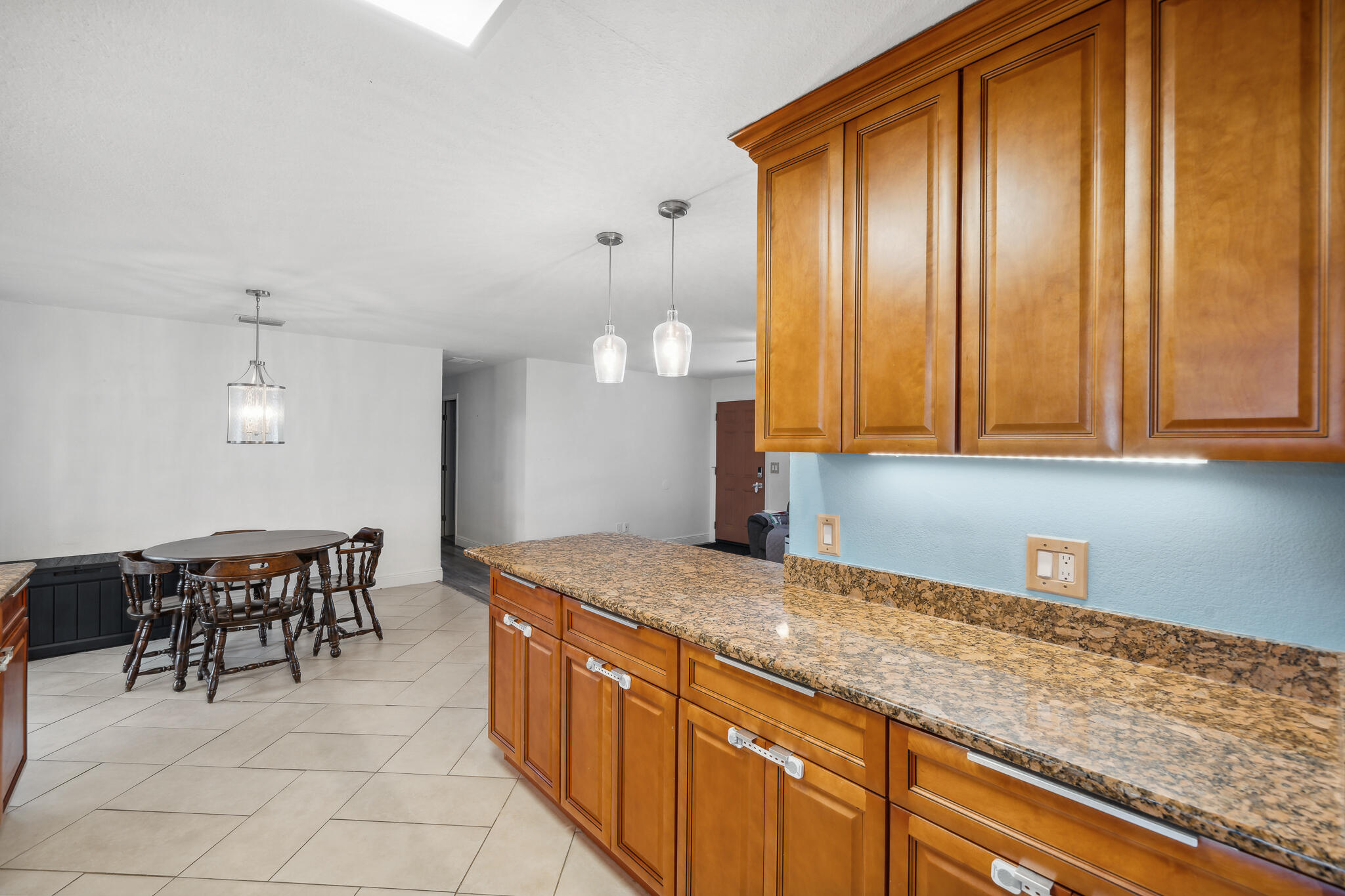 2936 Shepard Drive Rockledge, FL 32955 - Photo 4 of 25 a kitchen with granite countertop sink cabinets and stainless steel appliances