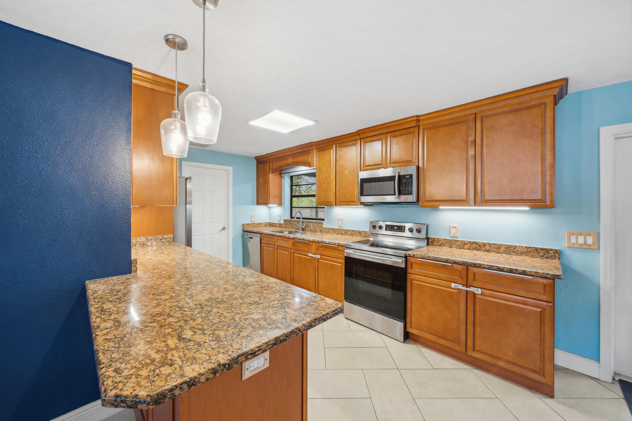 2936 Shepard Drive Rockledge, FL 32955 - Photo 5 of 25 a kitchen with stainless steel appliances granite countertop a sink stove and refrigerator