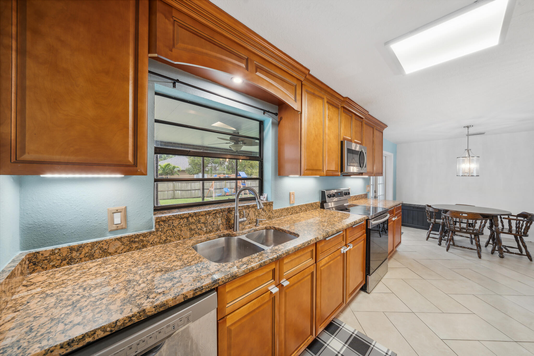 2936 Shepard Drive Rockledge, FL 32955 - Photo 7 of 25 a kitchen with stainless steel appliances granite countertop a sink and cabinets