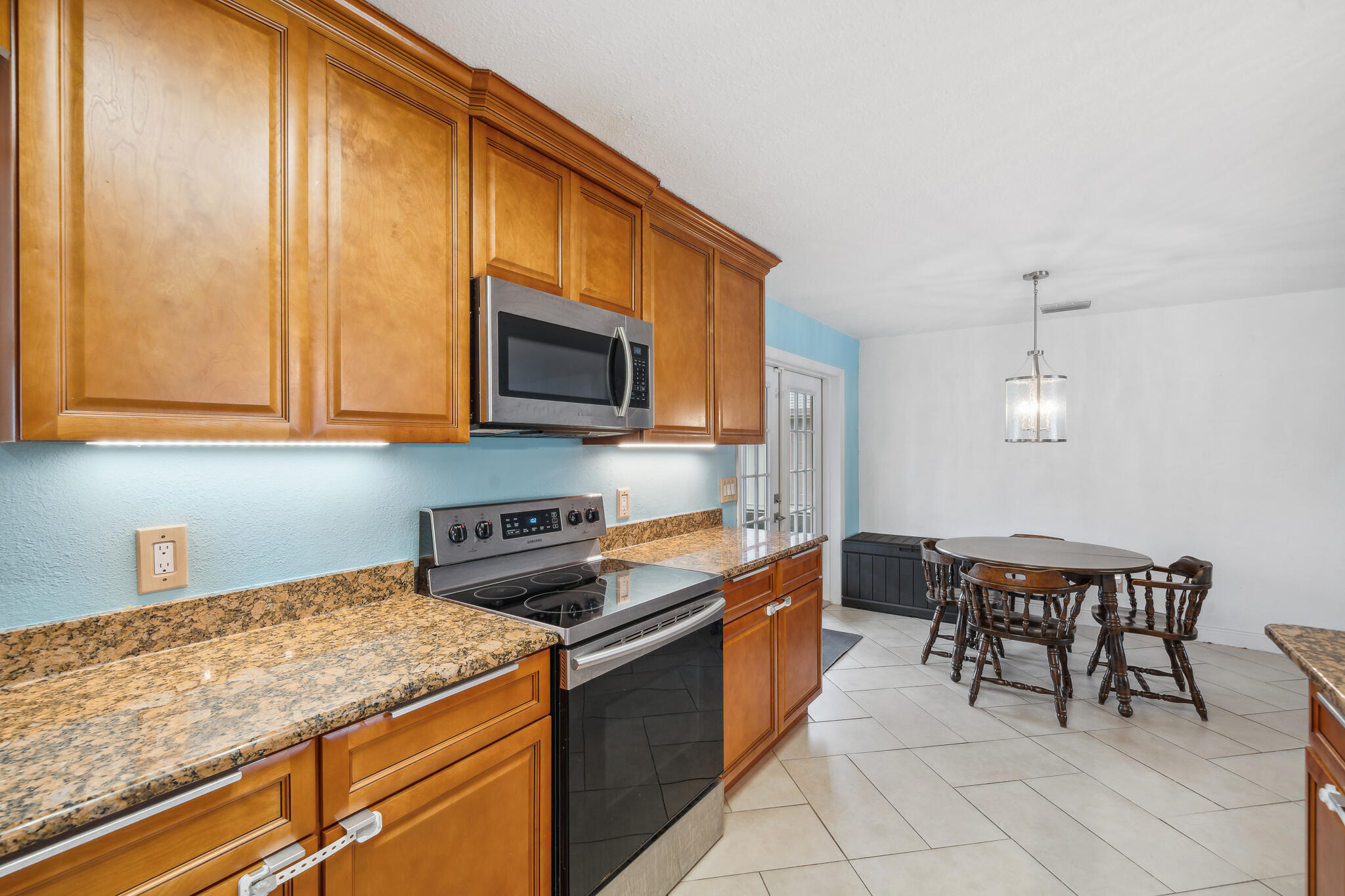 2936 Shepard Drive Rockledge, FL 32955 - Photo 8 of 25 a kitchen with stainless steel appliances granite countertop a sink and cabinets