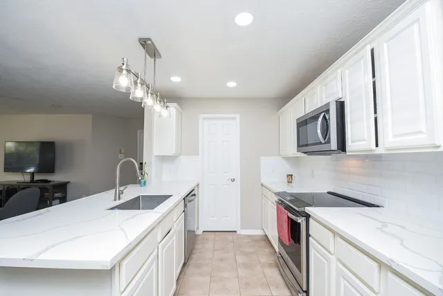 a kitchen with a sink and a refrigerator