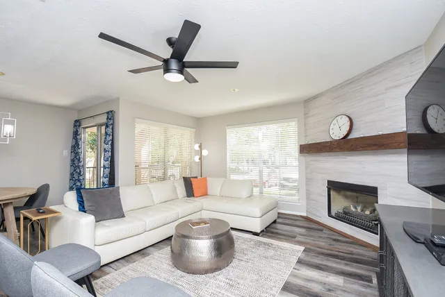 a living room with furniture and a fireplace