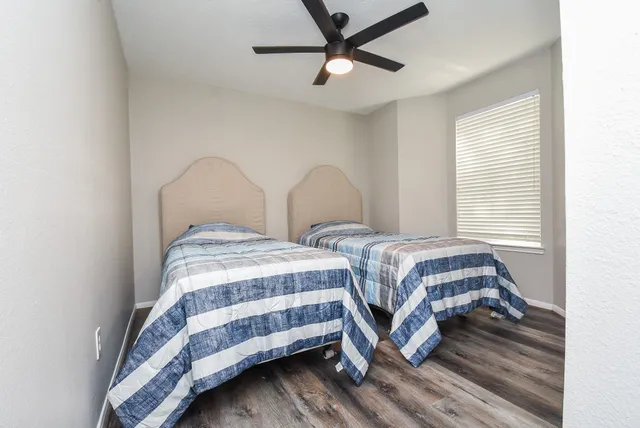a bedroom with two beds and a chandelier