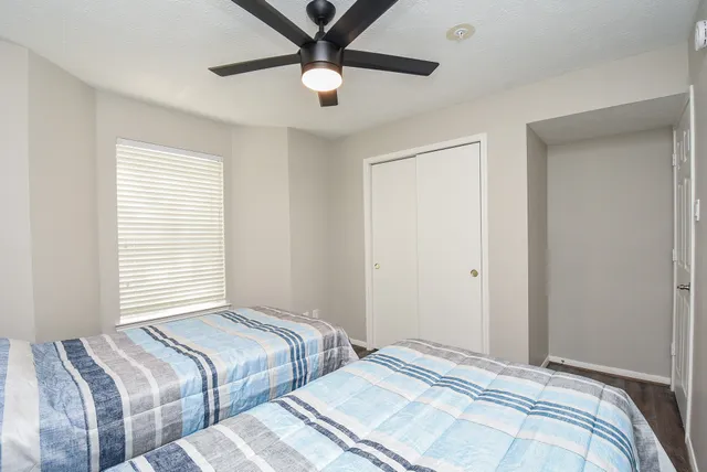 a bedroom with two large bed and a window
