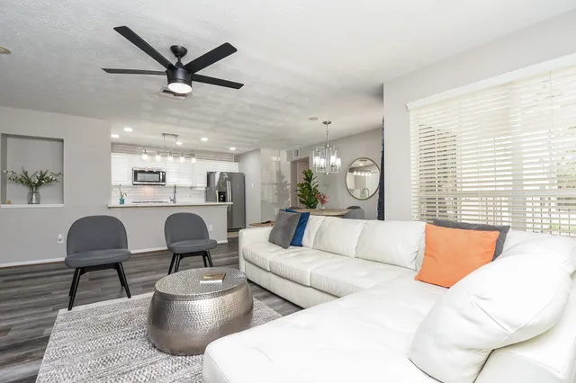 a living room with furniture and a large window