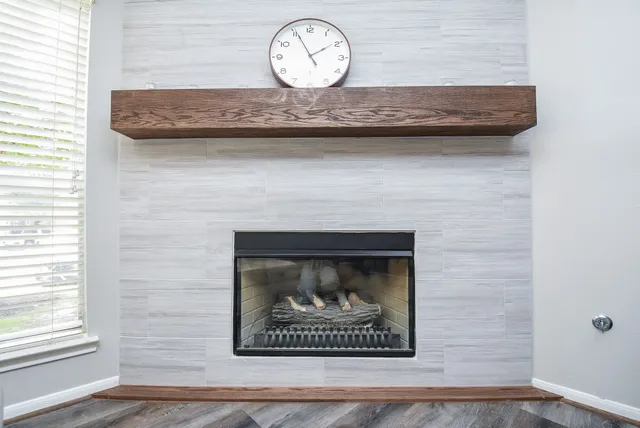 a stone wall with a clock on wall and a large window