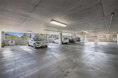 a front view of a building with garden space and street view