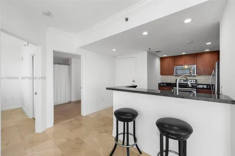 a kitchen with stainless steel appliances granite countertop a refrigerator stove and microwave