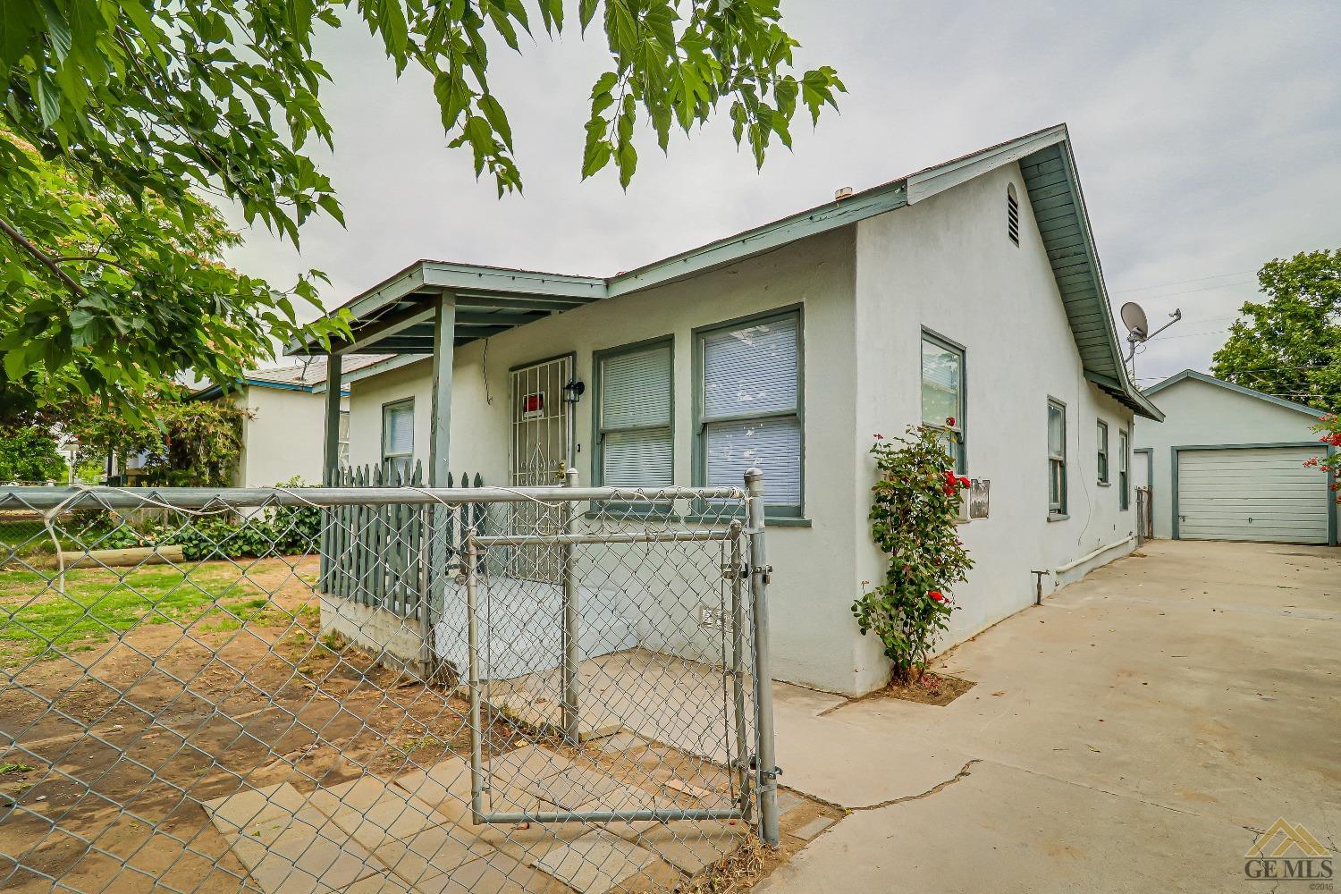 Undisclosed Address Bakersfield, CA 93308 - Photo 1 of 24 front view of house with a yard and potted plants