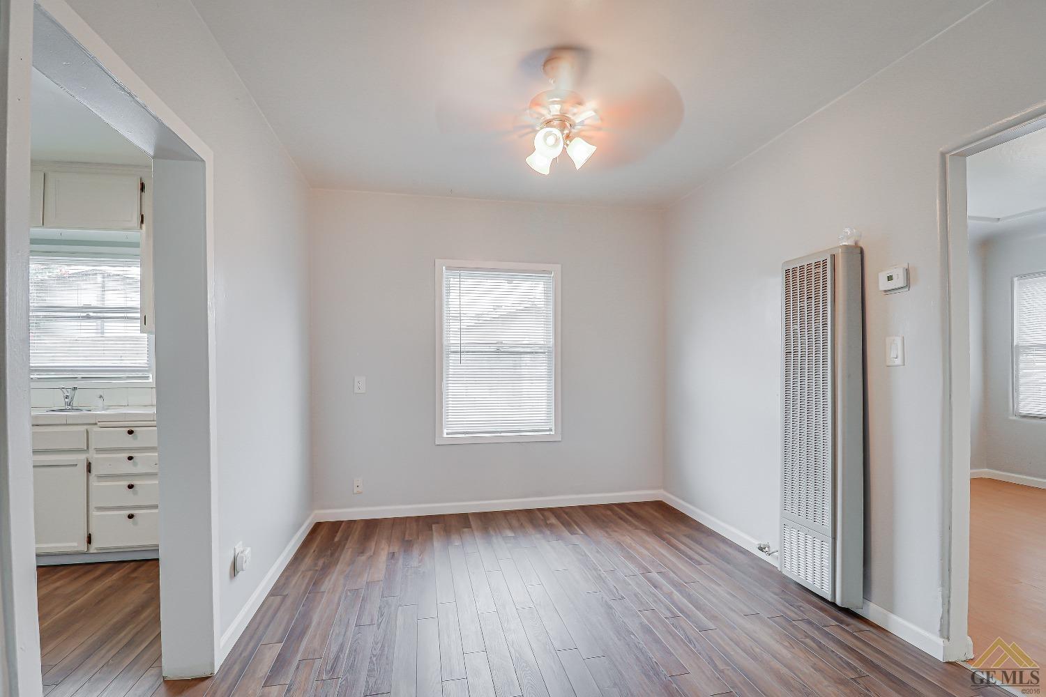 Undisclosed Address Bakersfield, CA 93308 - Photo 13 of 24 wooden floor in an empty room with a window