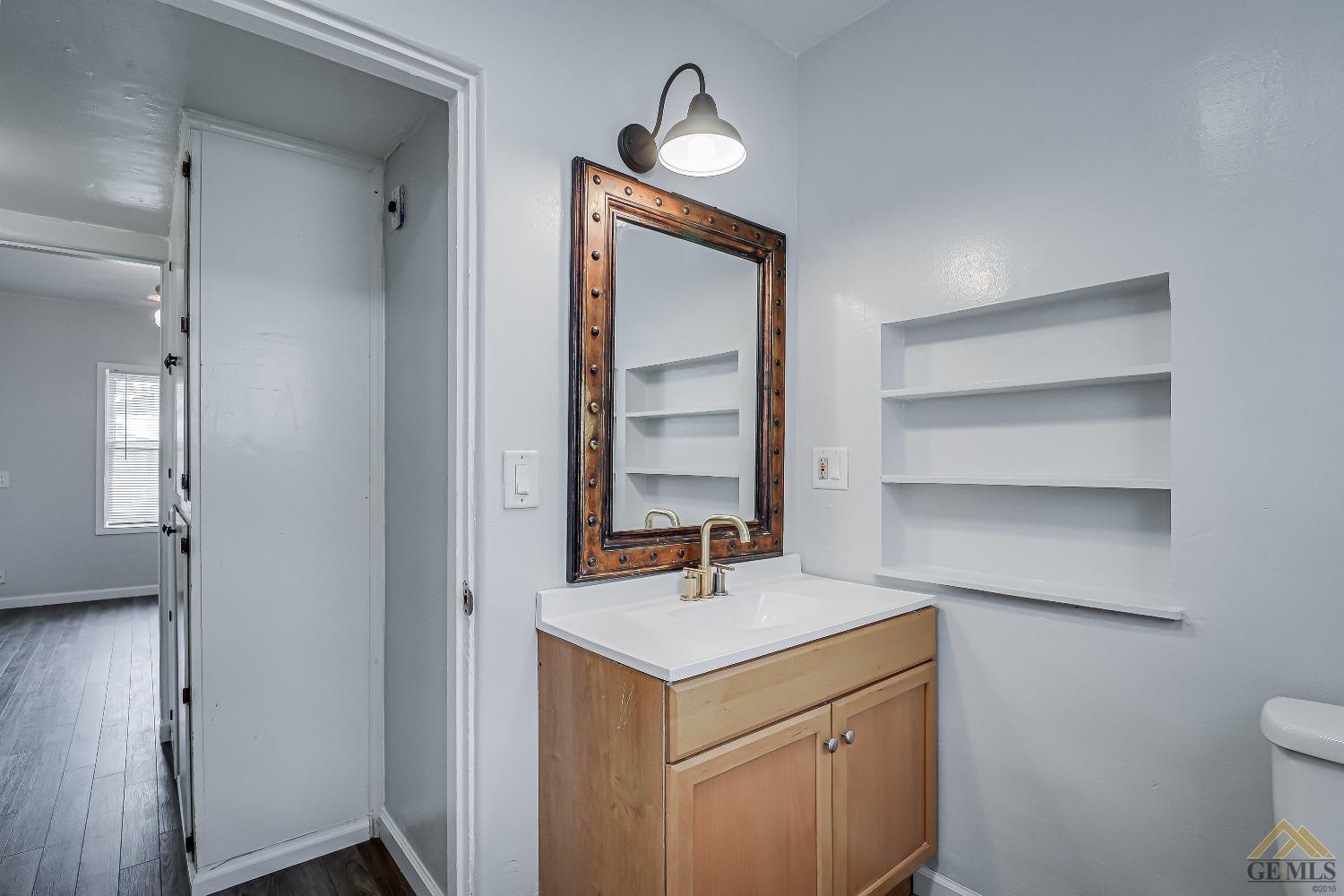 Undisclosed Address Bakersfield, CA 93308 - Photo 19 of 24 a room with a sink and a mirror