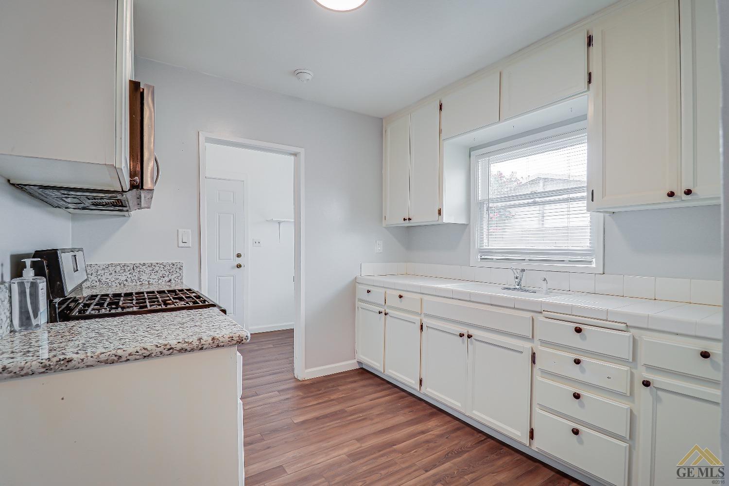 Undisclosed Address Bakersfield, CA 93308 - Photo 3 of 24 a kitchen with granite countertop a sink stainless steel appliances and cabinets