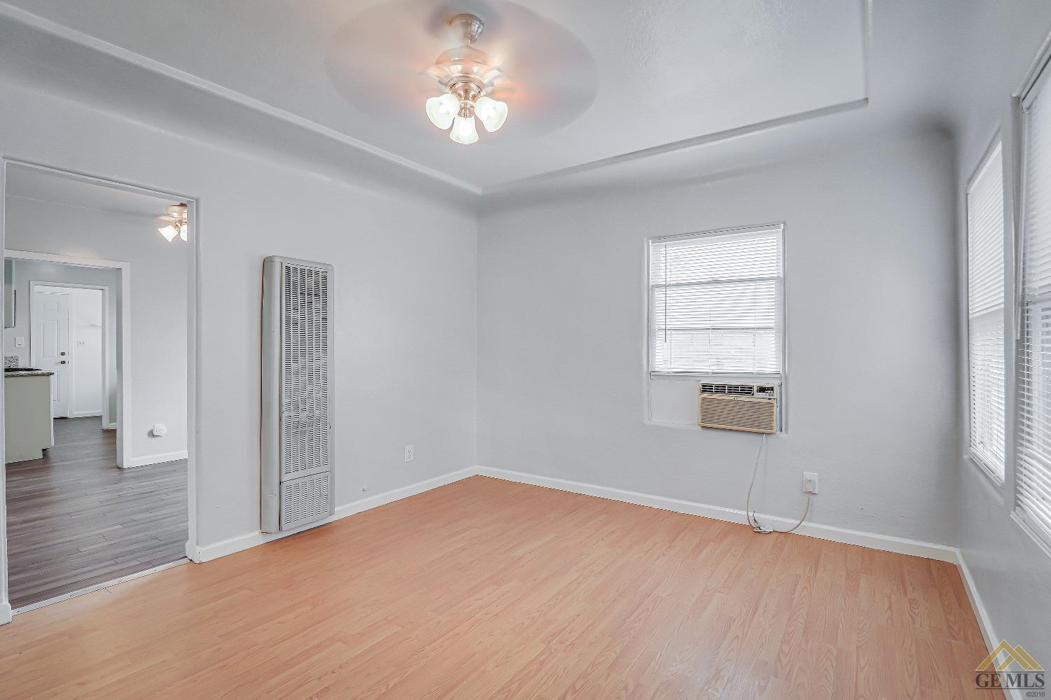 Undisclosed Address Bakersfield, CA 93308 - Photo 8 of 24 wooden floor in an empty room with a window