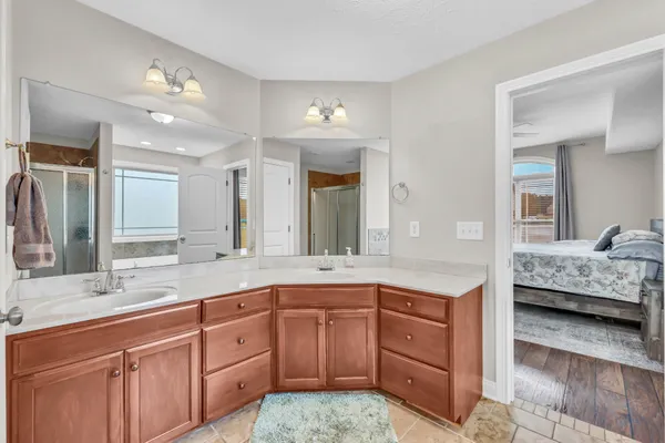 a spacious bathroom with a granite countertop sink and a mirror