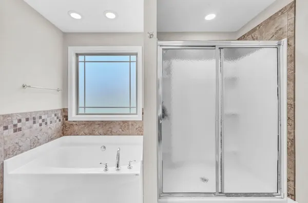 a bathroom with a bathtub and a shower