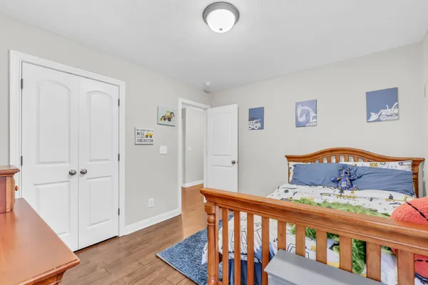 a bedroom with furniture and wooden floor