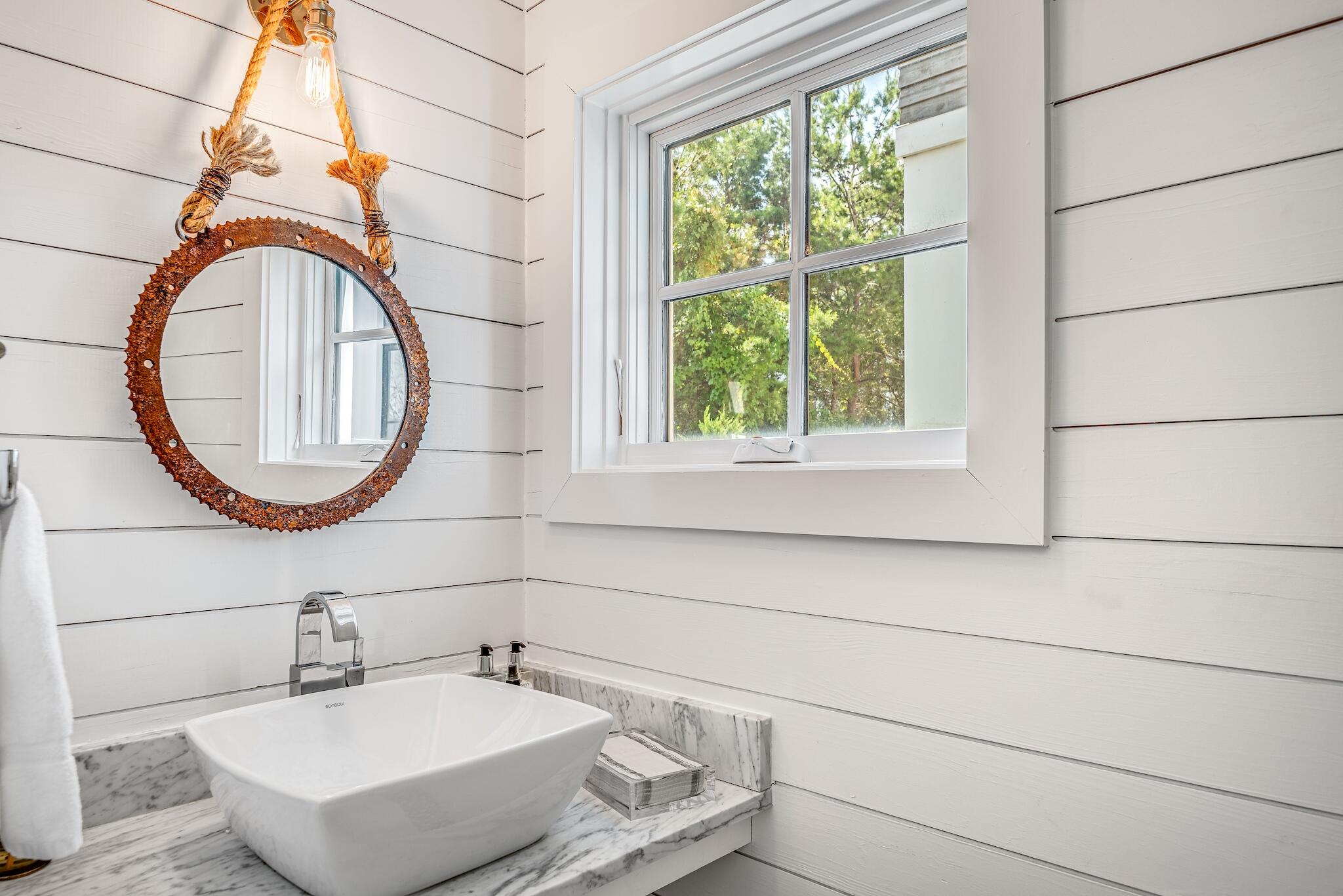 76 North Winston Ln Inlet Beach Inlet Beach, FL 32461 - Photo 11 of 48 a bathroom with a sink a mirror and a window
