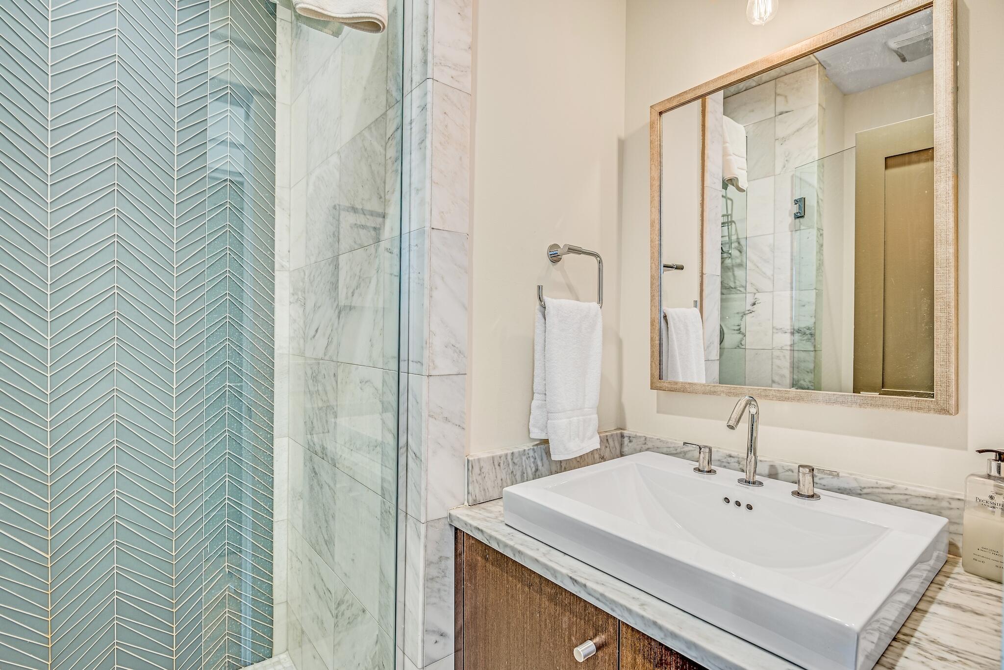 76 North Winston Ln Inlet Beach Inlet Beach, FL 32461 - Photo 16 of 48 a bathroom with a sink a mirror and a shower