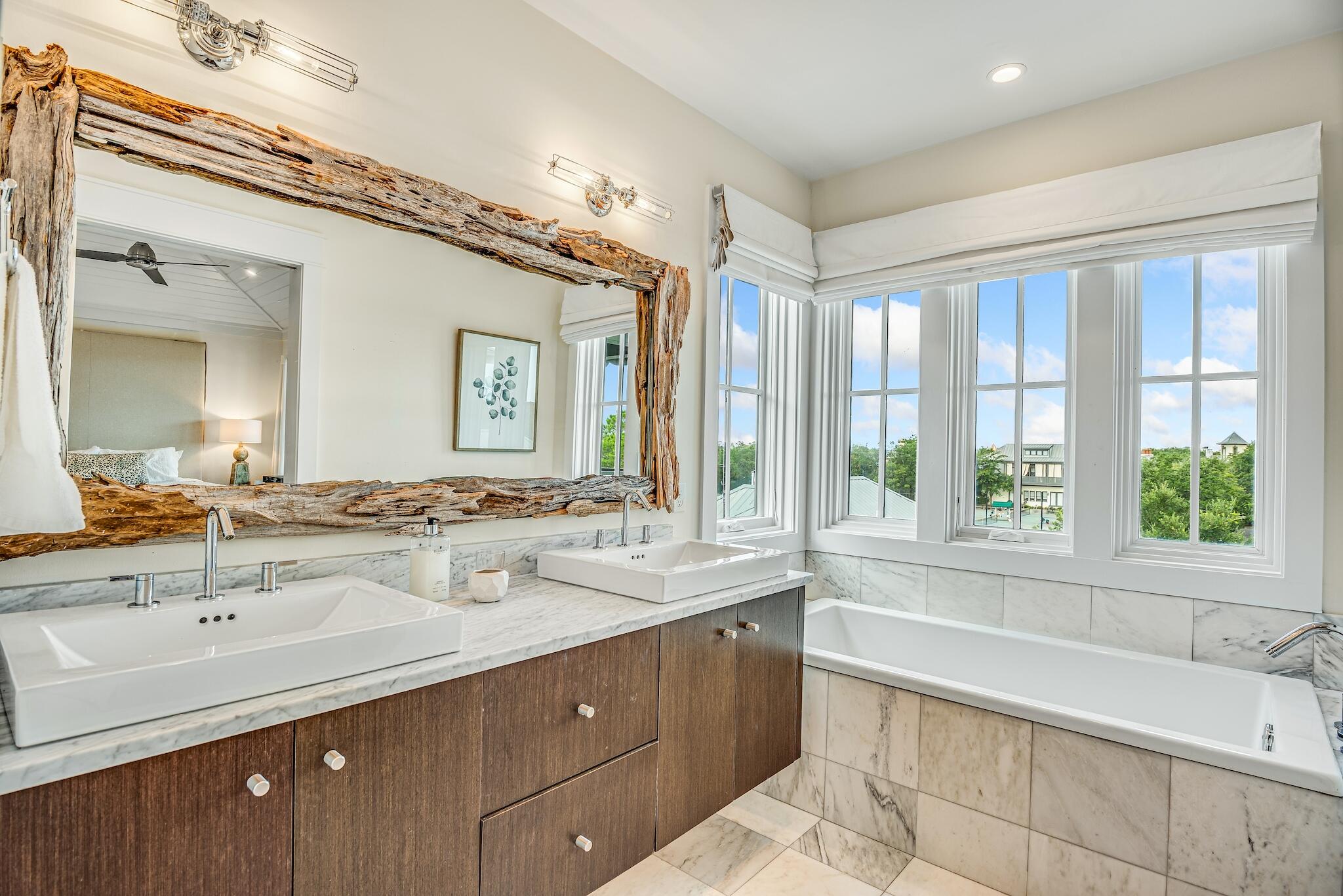 76 North Winston Ln Inlet Beach Inlet Beach, FL 32461 - Photo 30 of 48 a bathroom with a tub sink and mirror