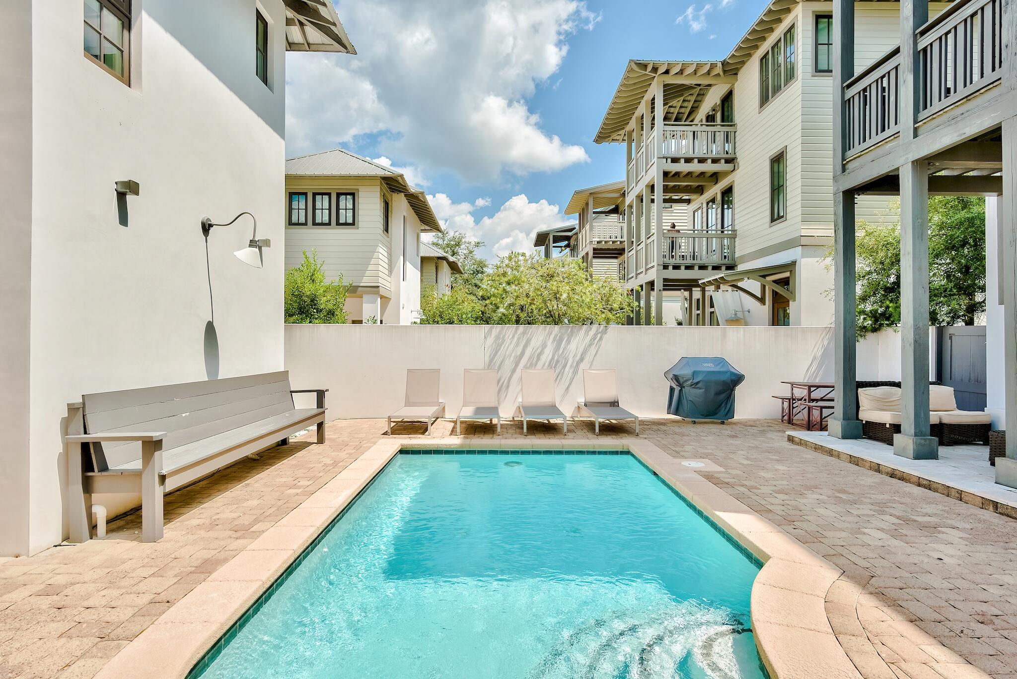 76 North Winston Ln Inlet Beach Inlet Beach, FL 32461 - Photo 44 of 48 a backyard of a house with table and chairs