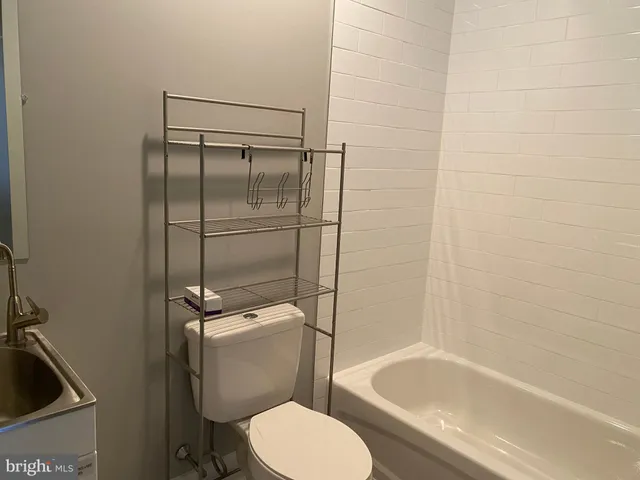 a kitchen with kitchen island a counter top space cabinets and stainless steel appliances