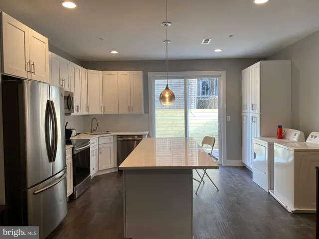 a en suite bathroom with a granite countertop toilet sink and shower
