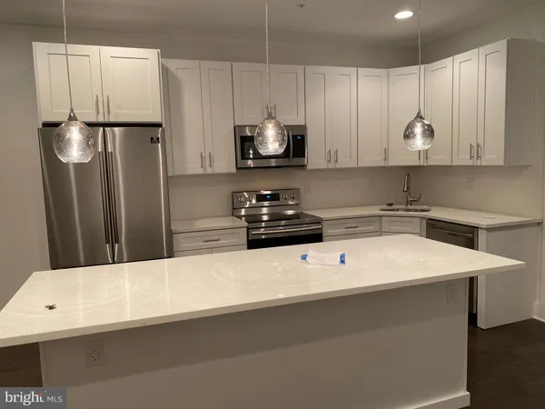 a kitchen with a refrigerator a sink and a stove