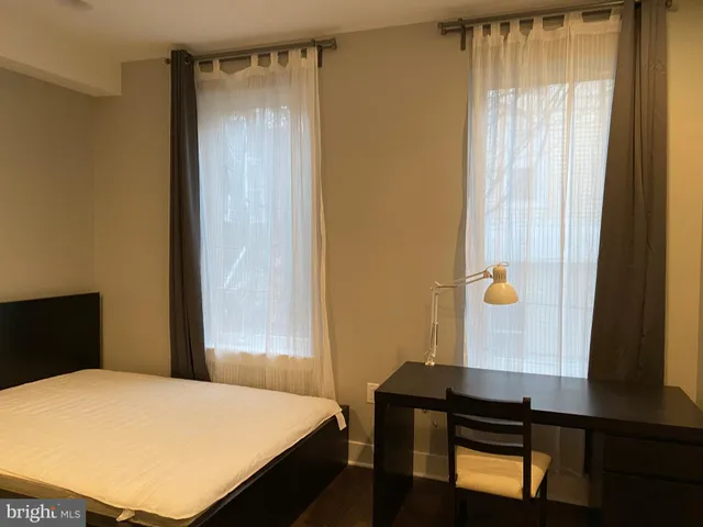 a kitchen with wooden floors and white appliances