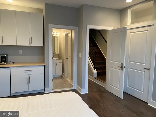 a room with a bed and cabinets