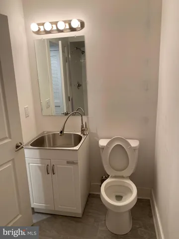 a bathroom with a toilet sink and mirror