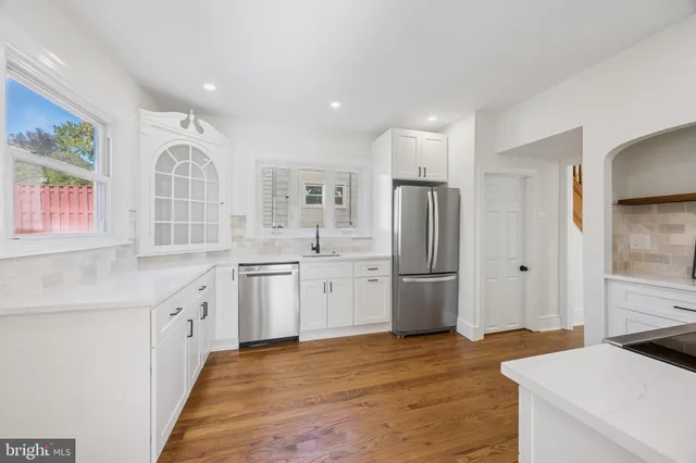 a kitchen with a sink stainless steel appliances and refrigerator