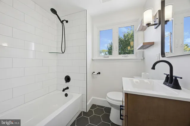 a bathroom with a sink a toilet and a bathtub