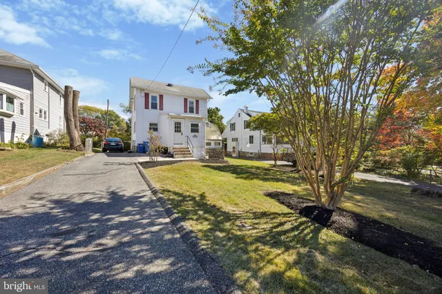 a backyard of a house with lots of green space and fountain