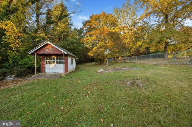 a view of a yard with a house in the background
