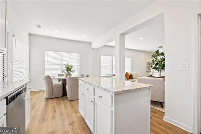 a view of living room with furniture and wooden floor