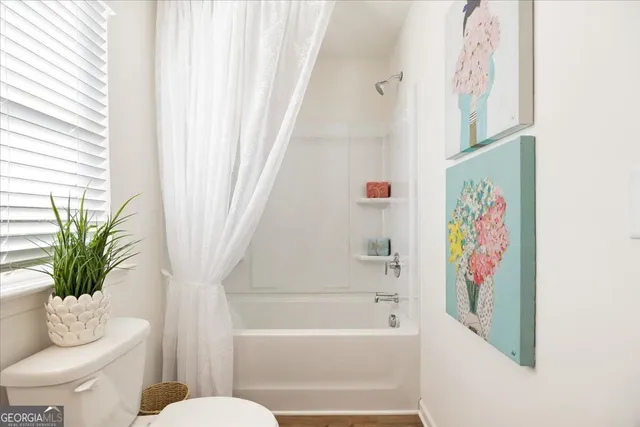 a bathroom with a bathtub and toilet